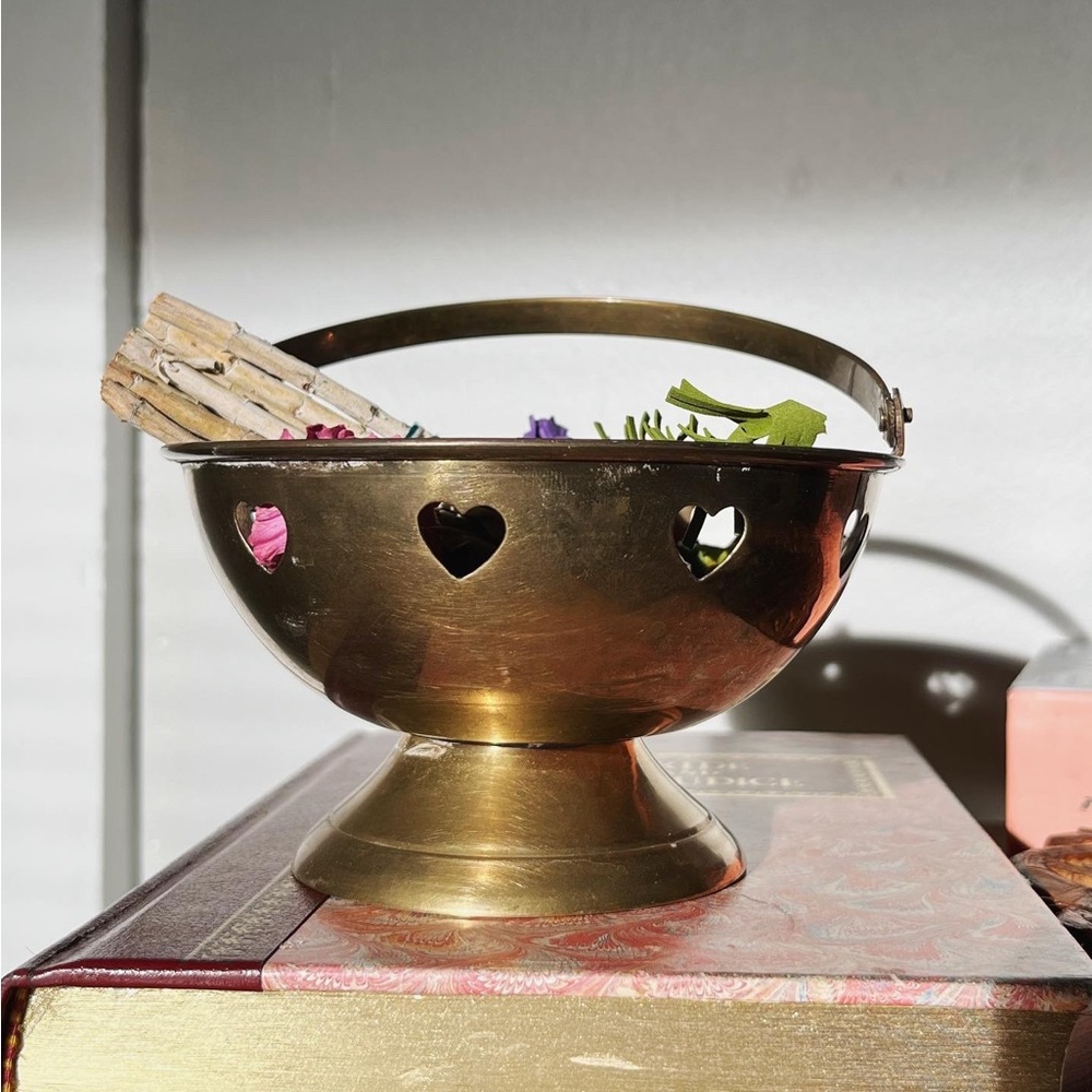 Small brass heart cauldron with handle.